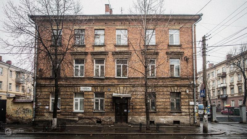 Brick facade of a 1913 apartment building on a Podil street in Kyiv, photographed in March 2025